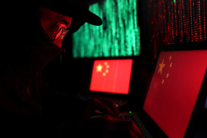 Hacker,In,A,Dark,Wearing,Hoody,And,Cap,Sitting,In