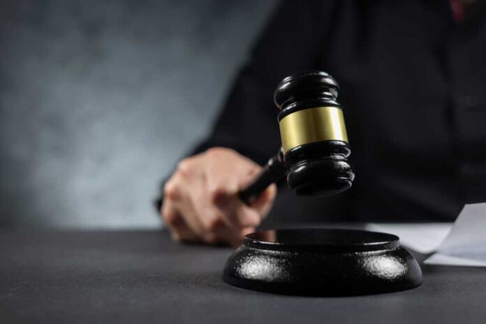 Judge's,Gavel,In,Hand,Judges,Is,Placed,On,A,Table
