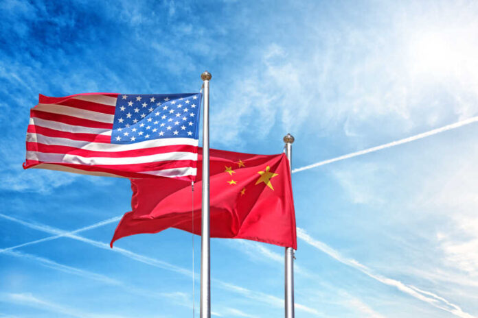 Usa,And,China,National,Flag,Waving,Against,Clouds,Blue,Sky