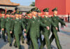 Group of uniformed soldiers marching in formation