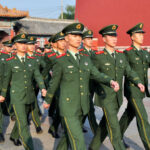 Group of uniformed soldiers marching in formation
