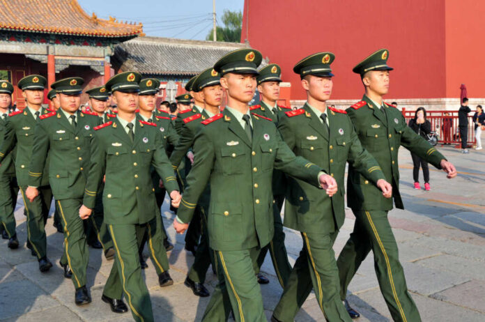 Group of uniformed soldiers marching in formation