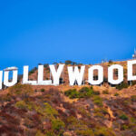 Hollywood sign on a hillside against a clear blue sky