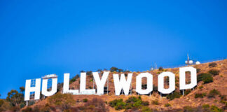 Hollywood sign on a hillside against a clear blue sky