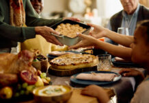 A family sharing a dish during a festive meal