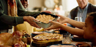 A family sharing a dish during a festive meal