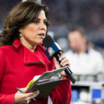 Sports reporter speaking into a microphone during a live event