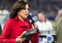Sports reporter speaking into a microphone during a live event