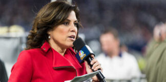 Sports reporter speaking into a microphone during a live event