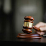 A wooden gavel resting on a desk, symbolizing justice and legal proceedings