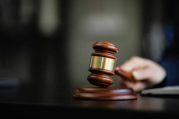 A wooden gavel resting on a desk, symbolizing justice and legal proceedings