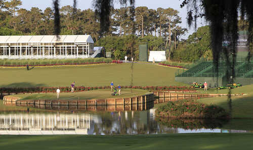 shutterstock_103438850 (1).jpg A scenic view of a golf course with players and maintenance equipment near a water feature