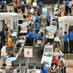 Senate Standoff Leaves 100,000 Workers Penniless Busy airport security checkpoint with travelers and TSA agents