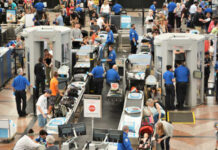 Senate Standoff Leaves 100,000 Workers Penniless Busy airport security checkpoint with travelers and TSA agents