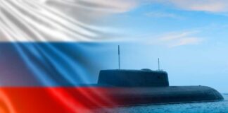 A submarine partially submerged in water with the Russian flag in the background