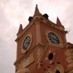 Blasphemy Scam EXPOSES Pakistan Horror A historic clock tower with a cloudy sky in the background