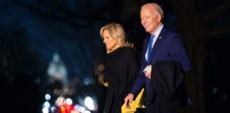 Joe and Jill Biden walking together outdoors at night