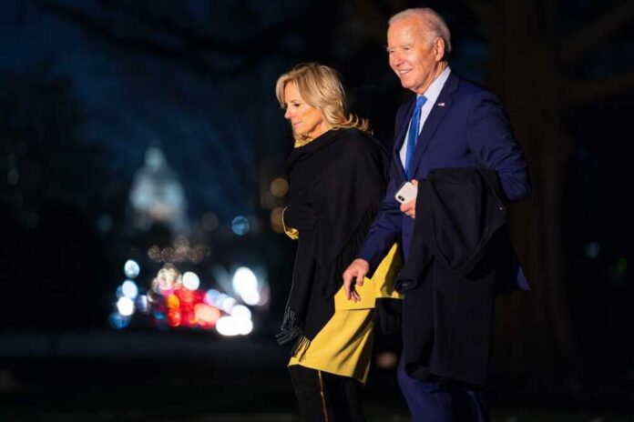 Joe and Jill Biden walking together outdoors at night
