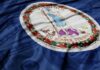 Virginia state flag featuring a central emblem on a blue background