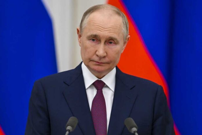 A serious-looking political figure at a press conference with national flags in the background
