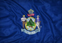 Maine state flag featuring its coat of arms on a blue background
