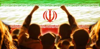 Crowd of people raising their fists in front of the Iranian flag