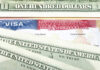 A collection of US dollar bills and a visa document