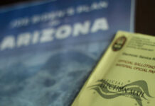 Election materials including a ballot envelope and a campaign brochure for Arizona
