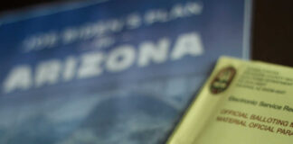 Election materials including a ballot envelope and a campaign brochure for Arizona