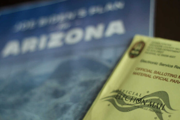 Election materials including a ballot envelope and a campaign brochure for Arizona