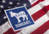 Democratic Party logo featuring a donkey on an American flag background