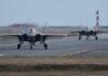 Two F-35 fighter jets taxiing on an airfield