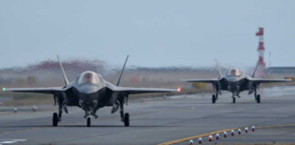 Two F-35 fighter jets taxiing on an airfield