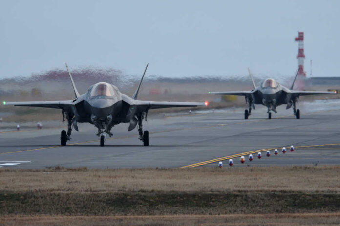 Two F-35 fighter jets taxiing on an airfield