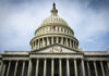 The U.S. Capitol building with an American flag flying in front
