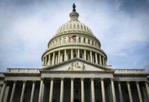The U.S. Capitol building with an American flag flying in front