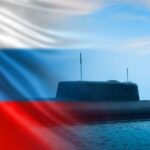 A submarine partially submerged in water with the Russian flag in the background