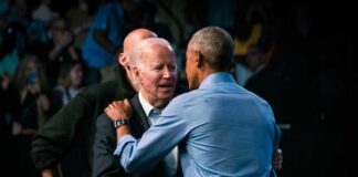 Two political leaders embracing and shaking hands at an event