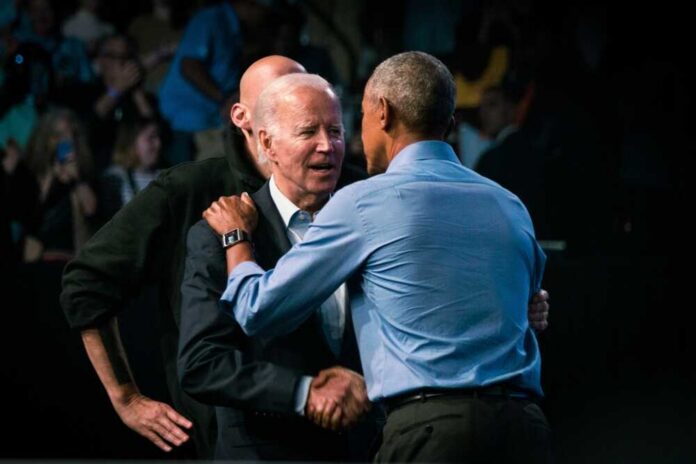 Two political leaders embracing and shaking hands at an event