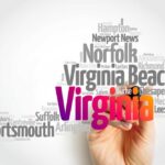 A hand holding a marker creating a word cloud of Virginia cities