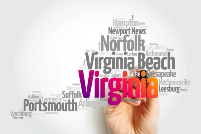 A hand holding a marker creating a word cloud of Virginia cities
