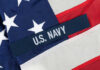 Close-up of the U.S. Navy insignia on an American flag