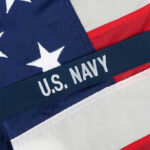 Deleted Post Exposes Democrats’ Humiliation Politics Close-up of the U.S. Navy insignia on an American flag