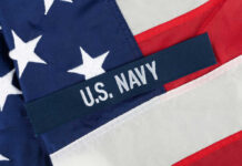 Close-up of the U.S. Navy insignia on an American flag