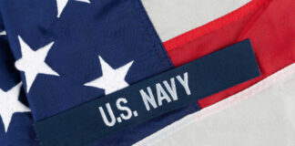 Close-up of the U.S. Navy insignia on an American flag