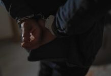 Hands behind back in handcuffs