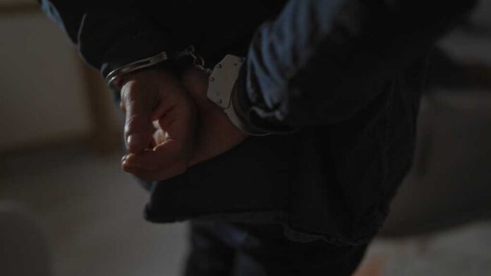 Hands behind back in handcuffs