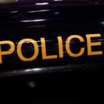 Close-up of a police vehicle with the word 'POLICE' prominently displayed