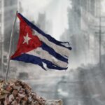 Tattered Cuban flag waving over a pile of rubble in a devastated urban landscape