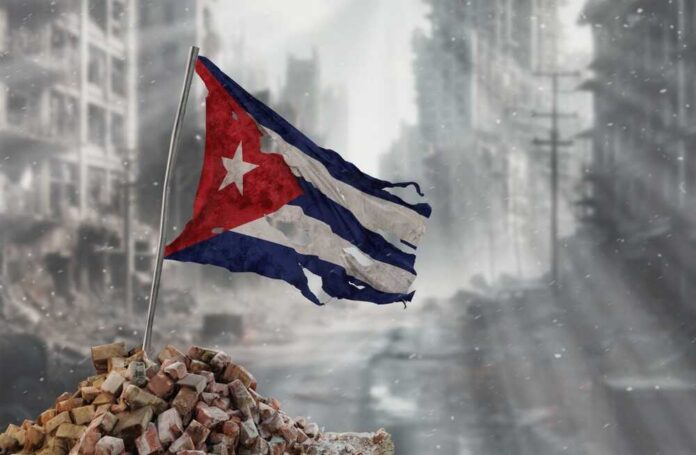 Tattered Cuban flag waving over a pile of rubble in a devastated urban landscape